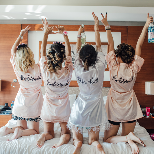 Bride with Bridesmaids wearing personalised robes on the wedding morning