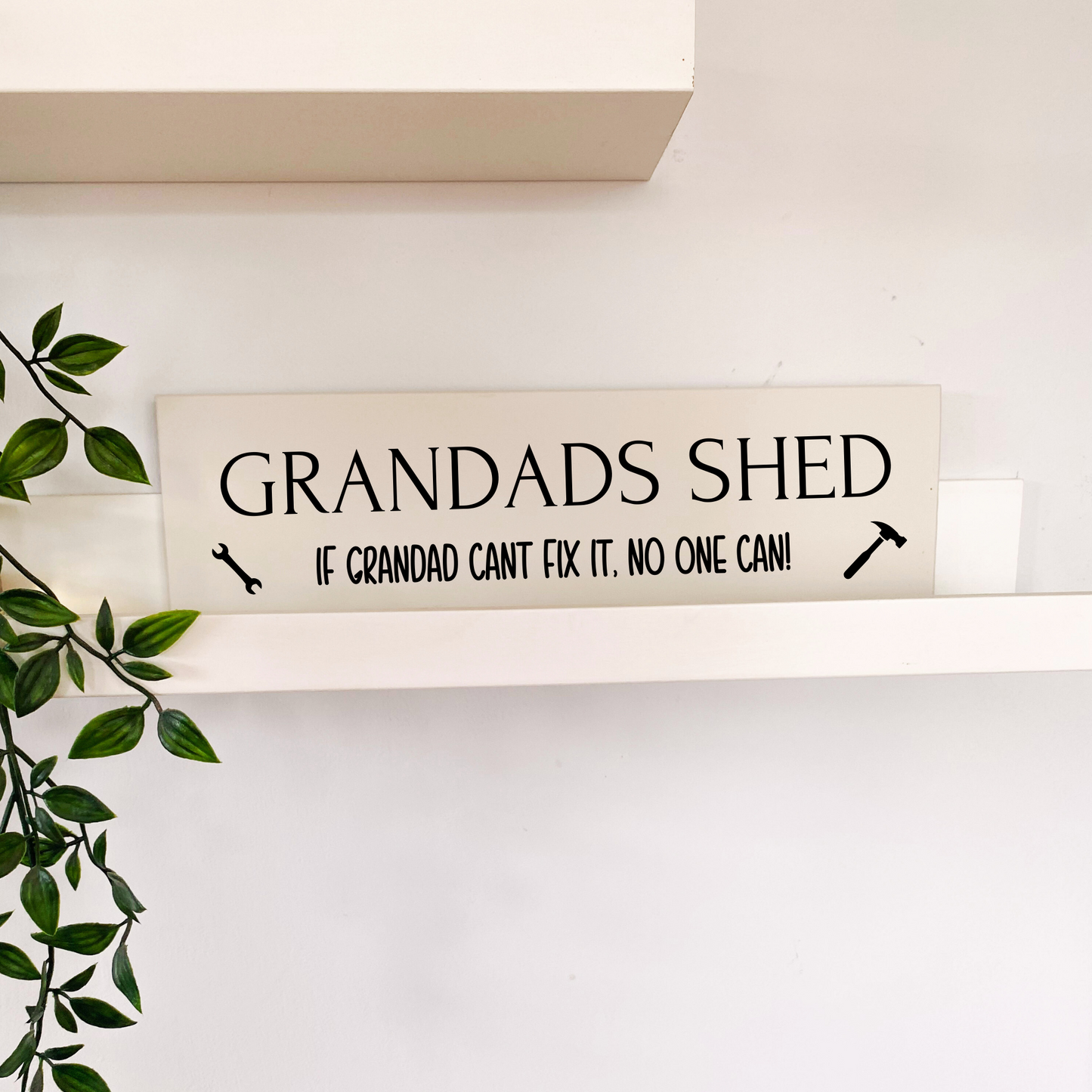 beige wooden sign for grandads shed